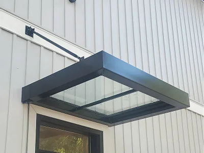 Entryway with decorative awning providing shelter